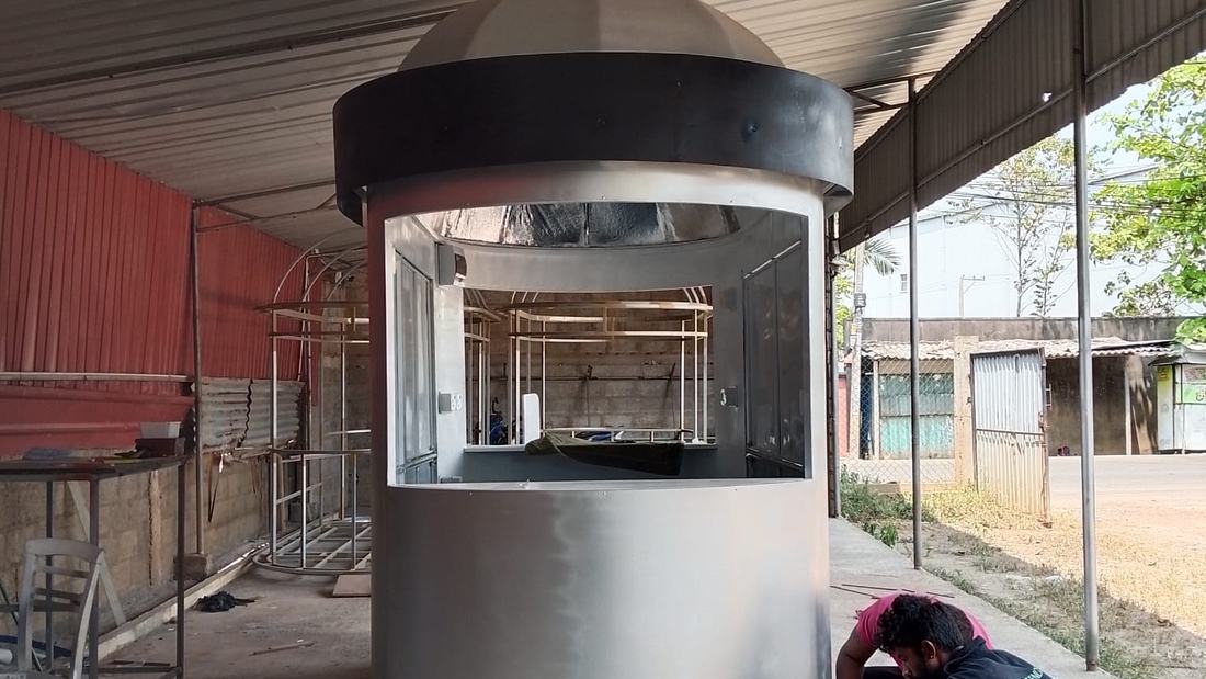 A cylindrical steel kiosk with a domed roof under fabrication in the SSMS workshop